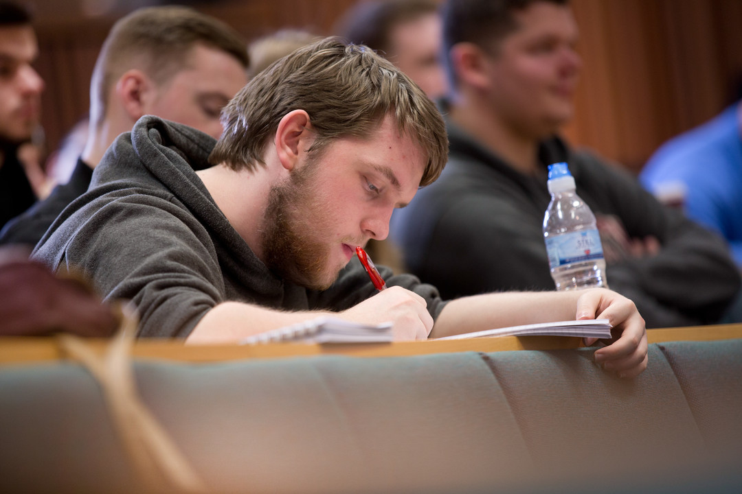 Student writing notes
