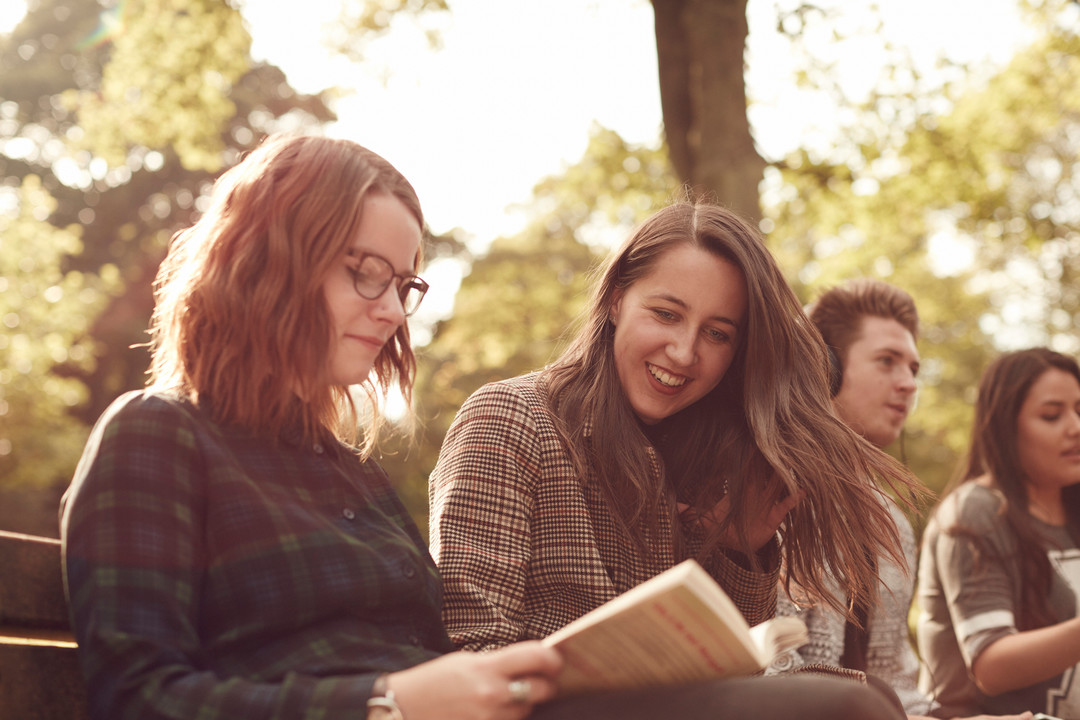 Students reading a book at barnes park