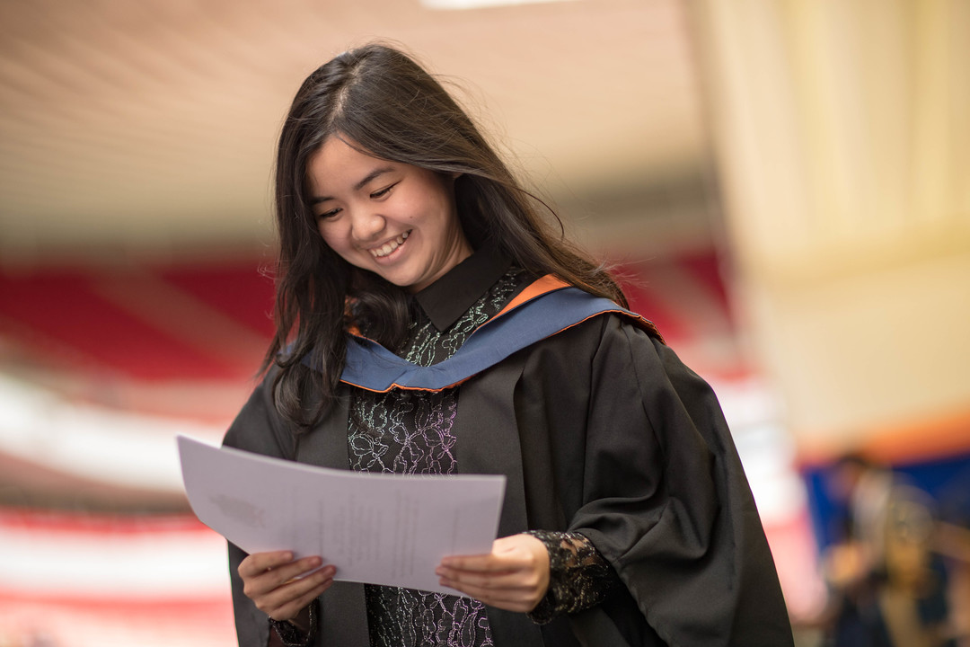 Student holding a certificate