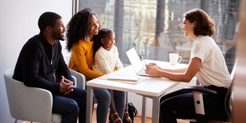Family in conversation with member of staff